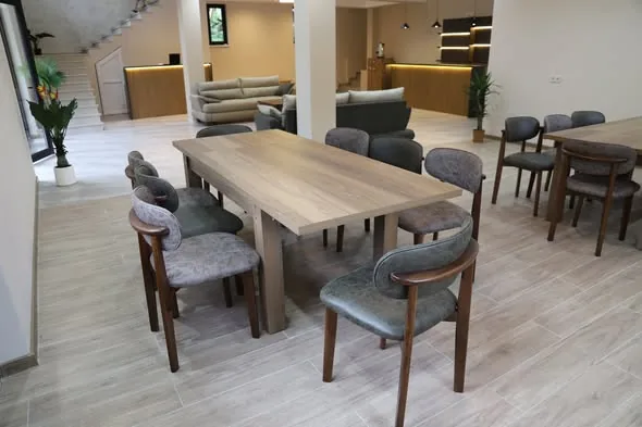 Long communal dining table at the Mestia guesthouse, set for the generous Georgian table
