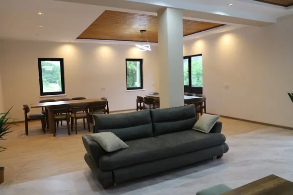 Bright shared lounge and dining area at the guesthouse in Mestia, Svaneti