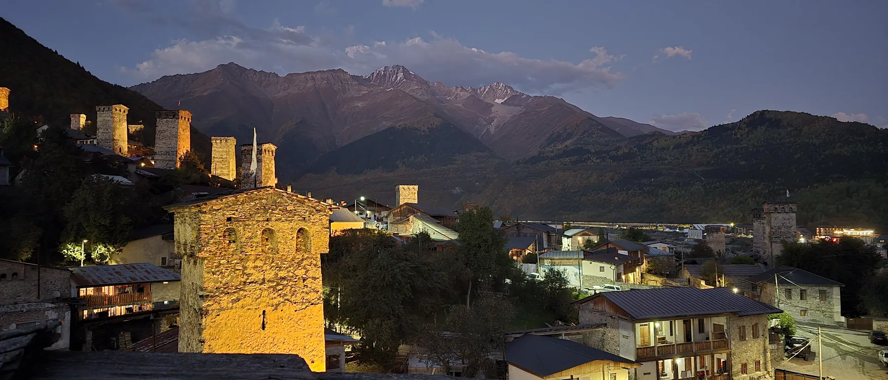 Svan towers lit at dusk in Mestia, Svaneti, Georgia