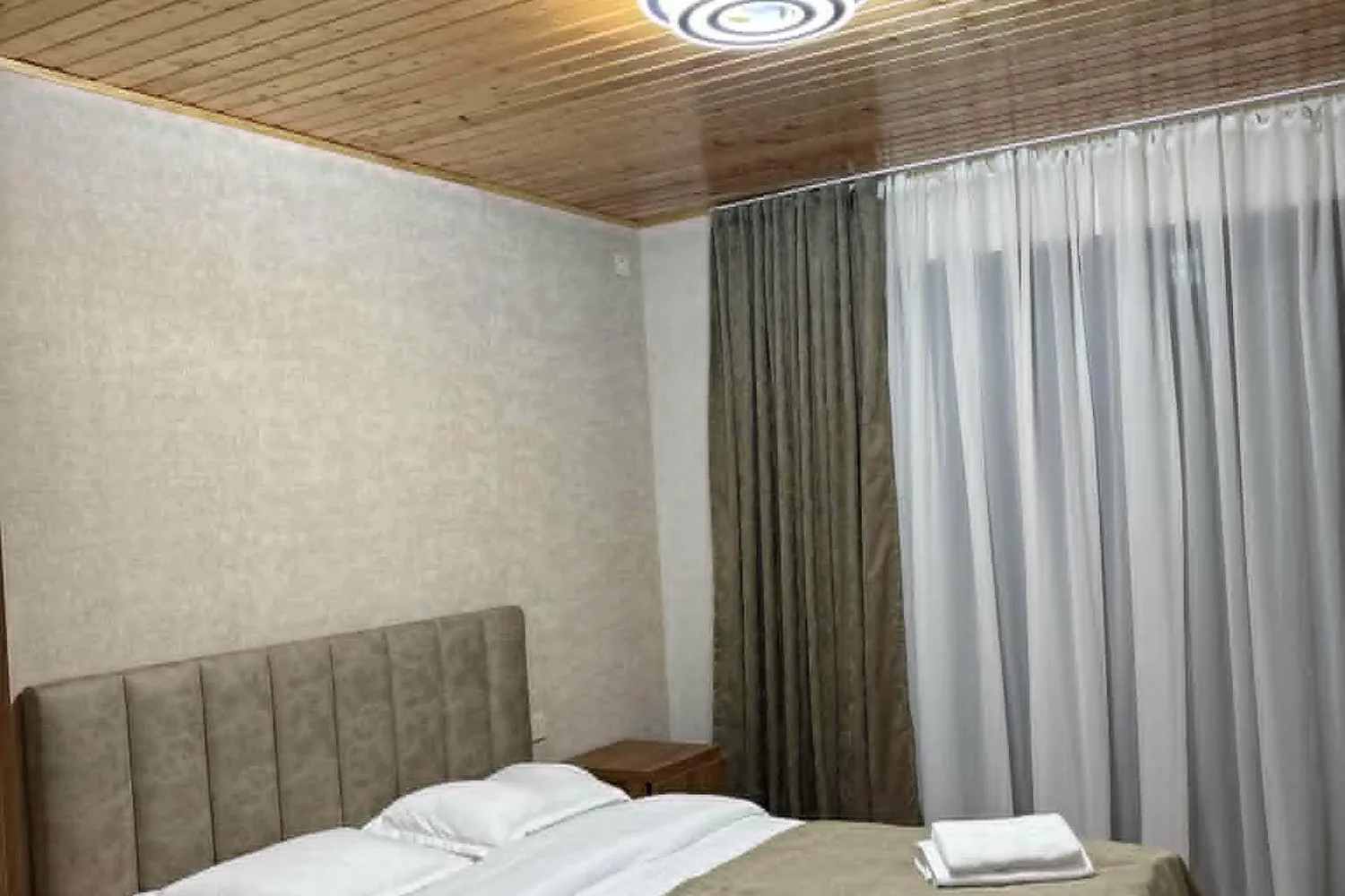 Guest room with a wooden ceiling in a Mestia guesthouse, Svaneti, Georgia