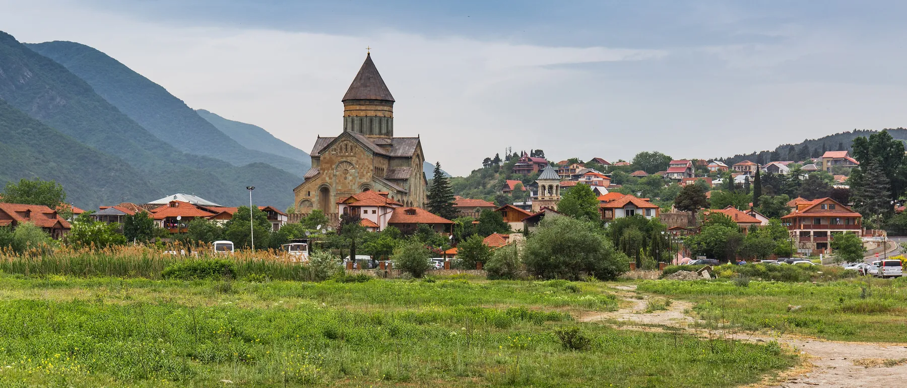 Svetitskhoveli Cathedral in Mtskheta below green mountains, Georgia