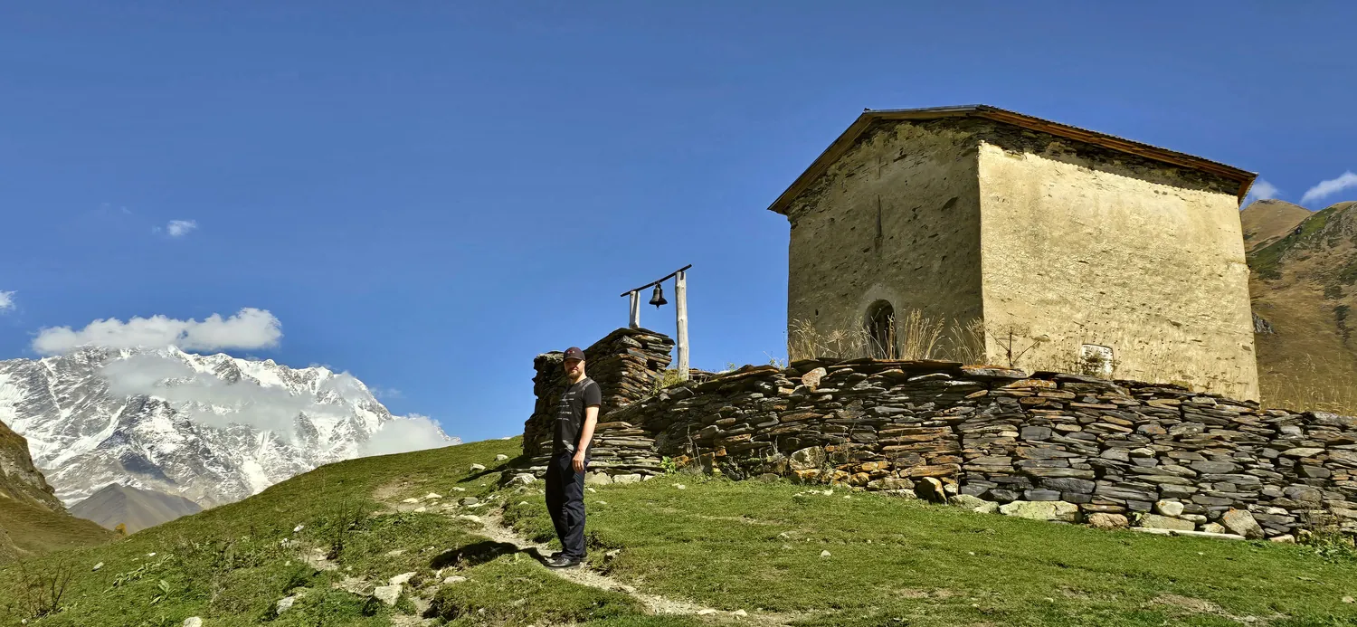 Jurijs, founder of Justvia, by a hilltop church near Ushguli, Georgia