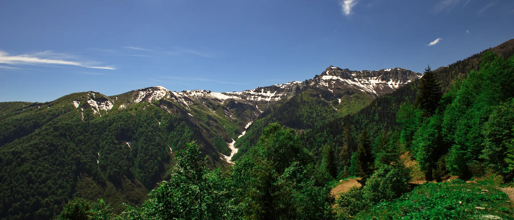 Wooded mountain slopes with snow on the ridges, Adjara, Georgia