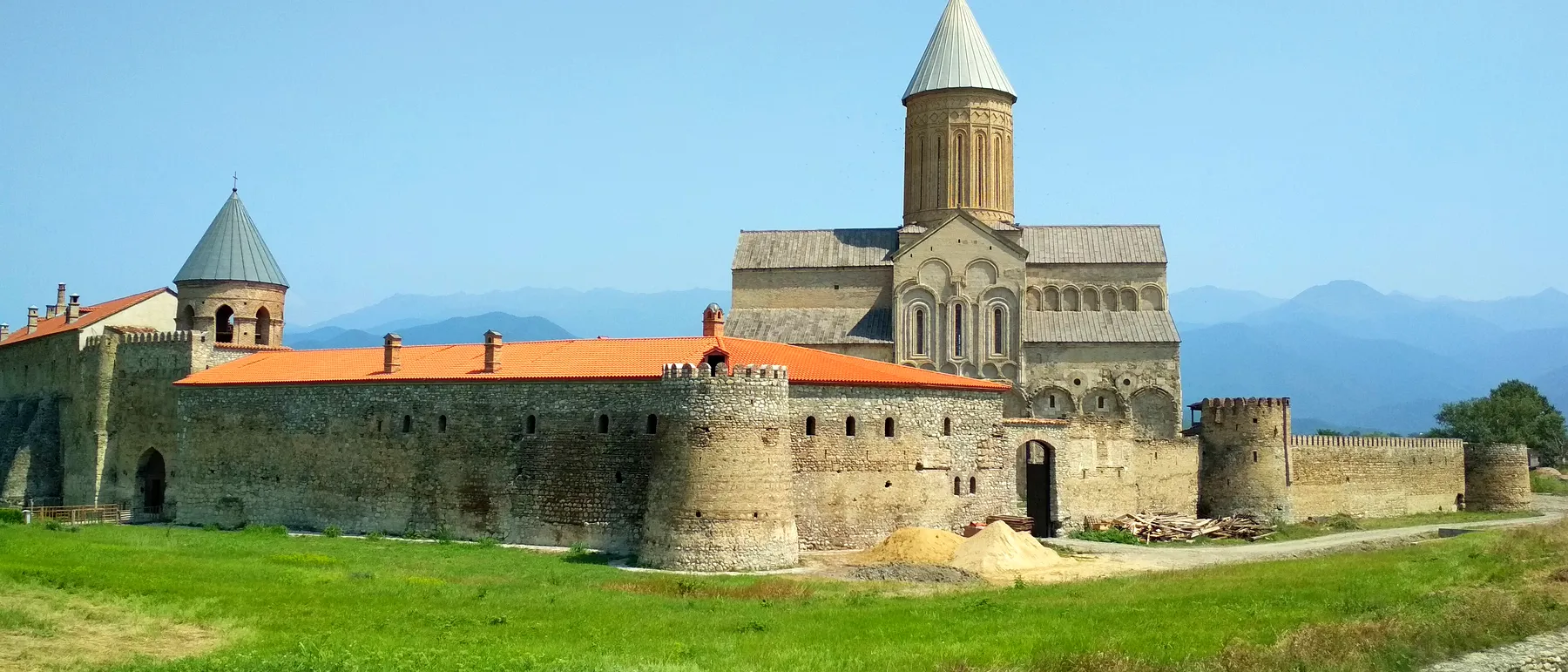 Alaverdi Cathedral and its fortified monastery walls with the Caucasus behind, Kakheti, Georgia