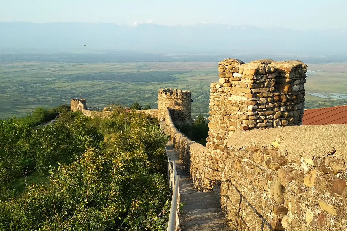 The stone town walls and towers of Sighnaghi with the wide Alazani valley below, Kakheti, Georgia